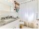 Bathroom featuring granite countertops, stylish shelves and shower featuring a patterned curtain at 13705 Allyn Dr, Hudson, FL 34667