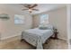 Cozy bedroom with natural light, a ceiling fan, and light-colored wood floors at 13705 Allyn Dr, Hudson, FL 34667