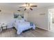 Bright bedroom with ceiling fan, wood floors and pier artwork at 13705 Allyn Dr, Hudson, FL 34667