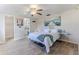 Bright bedroom with ceiling fan, wood floors and en-suite bathroom at 13705 Allyn Dr, Hudson, FL 34667