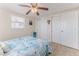 Comfortable bedroom with a ceiling fan, wood floors, and closet with sliding doors, offering ample storage at 13705 Allyn Dr, Hudson, FL 34667
