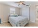 Comfortable bedroom with a ceiling fan and sliding closet doors at 13705 Allyn Dr, Hudson, FL 34667