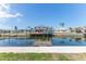 Spacious waterfront backyard featuring a dock, boat lift, and stunning canal views at 13705 Allyn Dr, Hudson, FL 34667