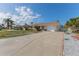 Single-story home with long driveway, attached garage, and well-kept landscaping at 13705 Allyn Dr, Hudson, FL 34667