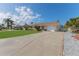 Single-story home with long driveway, attached garage, and well-kept landscaping at 13705 Allyn Dr, Hudson, FL 34667