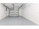 Spacious garage with an automatic door and painted walls offers secure parking and extra storage at 13705 Allyn Dr, Hudson, FL 34667