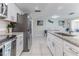 Open kitchen with stainless appliances, granite counters, and eat in kitchen at 13705 Allyn Dr, Hudson, FL 34667