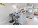 Modern kitchen island with granite countertop, bar stools, and stainless steel appliances, perfect for entertaining at 13705 Allyn Dr, Hudson, FL 34667
