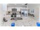 This renovated kitchen features stainless steel appliances, granite countertops, and white cabinets at 13705 Allyn Dr, Hudson, FL 34667