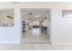 Open-concept living space with tile flooring, leading into kitchen and Gathering room areas at 13705 Allyn Dr, Hudson, FL 34667