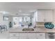 Bright living room with white cabinets and island, and granite countertops at 13705 Allyn Dr, Hudson, FL 34667