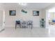 Open living room with tile floors and nautical decor is inviting and bright at 13705 Allyn Dr, Hudson, FL 34667