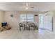Bright living room with tile floors, ceiling fan and outside view at 13705 Allyn Dr, Hudson, FL 34667