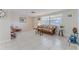 Bright and airy living room with tile flooring, wicker furniture, and a comfortable rocking chair at 13705 Allyn Dr, Hudson, FL 34667