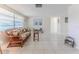 Spacious living room with tile flooring, wicker sofa, and bright windows, creating an open and airy feel at 13705 Allyn Dr, Hudson, FL 34667