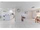Open concept living space connecting the kitchen and living area, featuring tile floors and natural light at 13705 Allyn Dr, Hudson, FL 34667