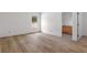 Bedroom with wood floors and view into bath at 16434 Medley Rd, Weeki Wachee, FL 34614