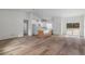 Open-concept living area with wood floors and kitchen with an island at 16434 Medley Rd, Weeki Wachee, FL 34614