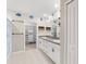 Bathroom featuring double sinks, granite countertops, and a spacious walk-in closet at 194 Argyll Dr, Spring Hill, FL 34609