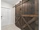 Rustic sliding barn door in the entryway adds character at 194 Argyll Dr, Spring Hill, FL 34609