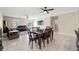 Open living room with a dining area featuring a grand clock and sliding doors at 194 Argyll Dr, Spring Hill, FL 34609