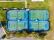 Aerial view of tennis and basketball courts within the community surrounded by lush green space at 20200 Lace Cascade Rd, Land O Lakes, FL 34637