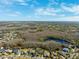 Panoramic aerial showcasing the community's houses, lakes, and trees with a clear blue sky backdrop at 20200 Lace Cascade Rd, Land O Lakes, FL 34637
