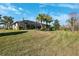A spacious backyard featuring lush grass and a screened-in porch for outdoor relaxation and entertainment at 20200 Lace Cascade Rd, Land O Lakes, FL 34637