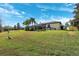 Expansive backyard with lush green grass and a screened-in patio, perfect for relaxation and outdoor gatherings at 20200 Lace Cascade Rd, Land O Lakes, FL 34637