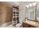Well-lit bathroom with a combination shower and tub, granite counters, and a decorative mirror at 20200 Lace Cascade Rd, Land O Lakes, FL 34637