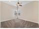 A bright, empty bedroom with neutral carpet, two windows with blinds, and a ceiling fan at 20200 Lace Cascade Rd, Land O Lakes, FL 34637