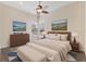 Stylishly furnished bedroom featuring neutral tones, a ceiling fan, and serene artwork enhancing a calming atmosphere at 20200 Lace Cascade Rd, Land O Lakes, FL 34637