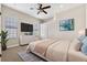 Bedroom with neutral carpet and a large window with blinds, a ceiling fan, and TV mounted on the wall at 20200 Lace Cascade Rd, Land O Lakes, FL 34637