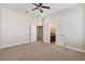 Bright, airy bedroom with neutral carpet, an open doorway to the bathroom, and another doorway at 20200 Lace Cascade Rd, Land O Lakes, FL 34637