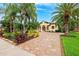 Beautiful home with a brick driveway, mature landscaping, and a well-maintained lawn at 20200 Lace Cascade Rd, Land O Lakes, FL 34637