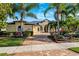 Stately home featuring lush landscaping, mature trees, and a brick driveway, offering curb appeal and charm at 20200 Lace Cascade Rd, Land O Lakes, FL 34637