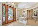 Elegant foyer showcasing a decorative front door, chandelier, and view into dining area at 20200 Lace Cascade Rd, Land O Lakes, FL 34637