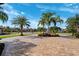 Beautiful home featuring a brick driveway, lush landscaping, and mature palm trees on a sunny day at 20200 Lace Cascade Rd, Land O Lakes, FL 34637
