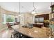 Bright kitchen features granite countertops, island with seating, stainless appliances, and lovely backyard views at 20200 Lace Cascade Rd, Land O Lakes, FL 34637