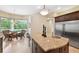 Kitchen with granite countertops, a breakfast bar, and stainless steel refrigerator is ideal for gatherings at 20200 Lace Cascade Rd, Land O Lakes, FL 34637