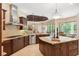 This gourmet kitchen showcases stainless appliances, granite countertops, custom cabinets, and an island with seating at 20200 Lace Cascade Rd, Land O Lakes, FL 34637