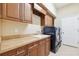 Laundry room with wooden cabinets, laminate countertops, sink, washer, and dryer at 20200 Lace Cascade Rd, Land O Lakes, FL 34637