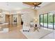 Bright and open living room with plush seating, decorative ceiling, and views of the pool area at 20200 Lace Cascade Rd, Land O Lakes, FL 34637