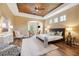 This spacious bedroom features wood floors, a decorative ceiling, neutral paint, and ample natural light at 20200 Lace Cascade Rd, Land O Lakes, FL 34637