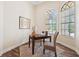 Home office with hardwood floors, neutral walls, and large windows provides a quiet workspace at 20200 Lace Cascade Rd, Land O Lakes, FL 34637