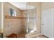 Modern shower with frameless glass enclosure, tiled walls, rain shower head and bench, exuding spa-like tranquility at 20200 Lace Cascade Rd, Land O Lakes, FL 34637