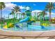 Community splash pad with play features and a pool surrounded by lush landscaping at 20200 Lace Cascade Rd, Land O Lakes, FL 34637