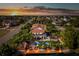 Stunning waterfront home featuring a private dock, pool, and lush tropical landscaping at sunset at 3308 Oleander Dr, Hernando Beach, FL 34607