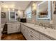 Bathroom featuring double sinks, granite countertops, and well lit mirrors at 3308 Oleander Dr, Hernando Beach, FL 34607