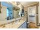 Bathroom featuring granite vanity, a large mirror, and shower and washer dryer area at 3308 Oleander Dr, Hernando Beach, FL 34607